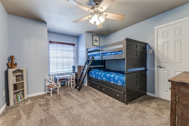 bedroom featuring ceiling fan, light colored carpet, and a textured ceiling