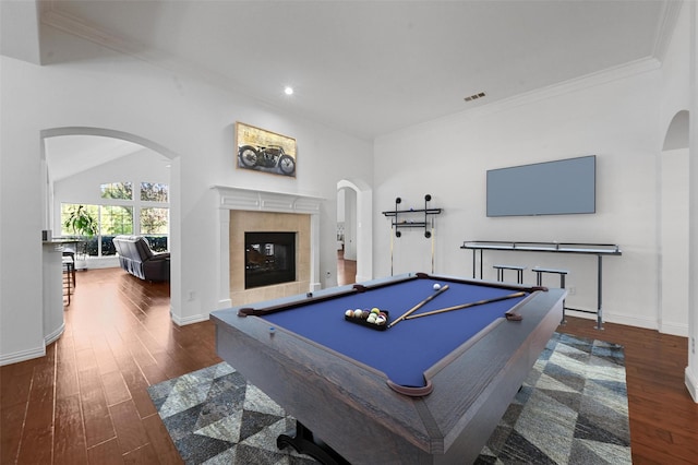 rec room with dark hardwood / wood-style flooring, crown molding, pool table, and a tile fireplace