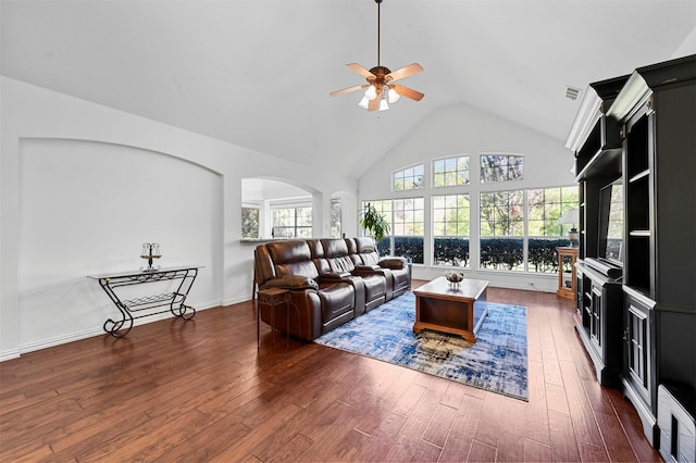 living room featuring ceiling fan, high vaulted ceiling, and dark wood-type flooring