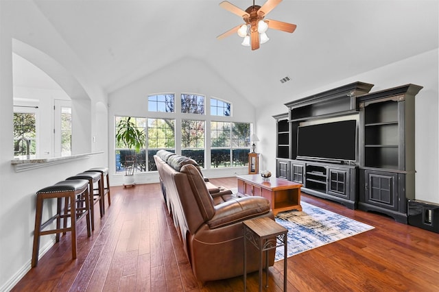 living room featuring dark wood-type flooring, high vaulted ceiling, and ceiling fan