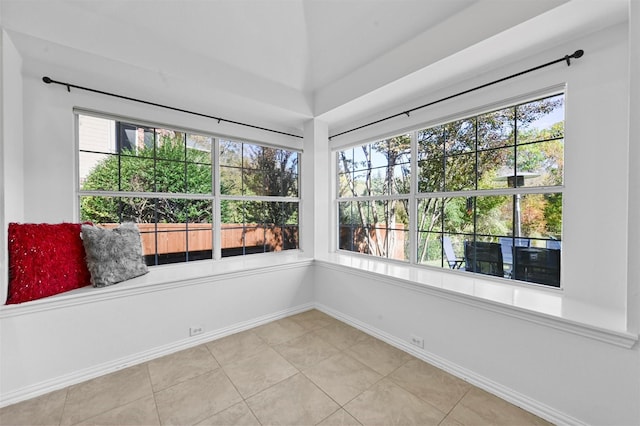 unfurnished sunroom with lofted ceiling