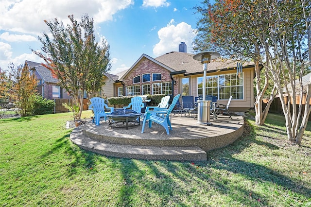 rear view of house featuring a lawn, an outdoor fire pit, and a patio