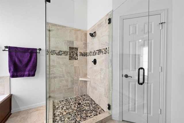 bathroom with a shower with door