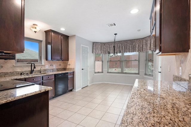 kitchen featuring sink, light tile patterned floors, dishwasher, a notable chandelier, and pendant lighting