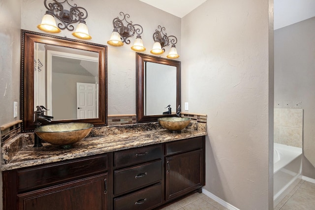 bathroom with vanity, tile patterned flooring, and a bathtub