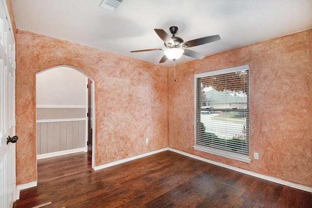 empty room featuring ceiling fan and dark hardwood / wood-style floors