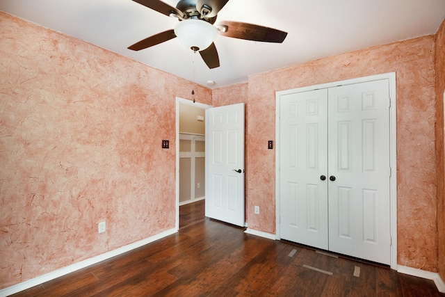 unfurnished bedroom with ceiling fan, dark hardwood / wood-style floors, and a closet