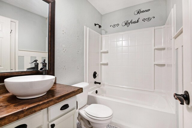 full bathroom with vanity, washtub / shower combination, and toilet