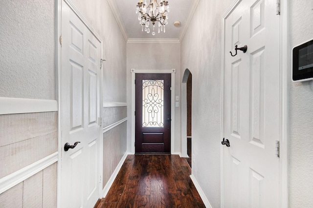 foyer entrance featuring crown molding, dark hardwood / wood-style floors, and a notable chandelier