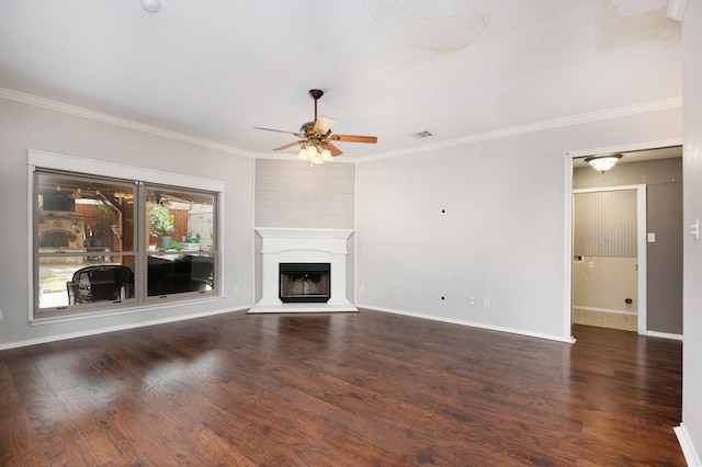 unfurnished living room featuring dark wood-type flooring, ceiling fan, and ornamental molding