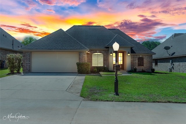 view of front of property with a lawn and a garage