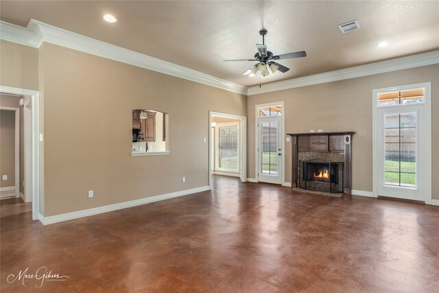 unfurnished living room featuring a premium fireplace, ceiling fan, a textured ceiling, and ornamental molding