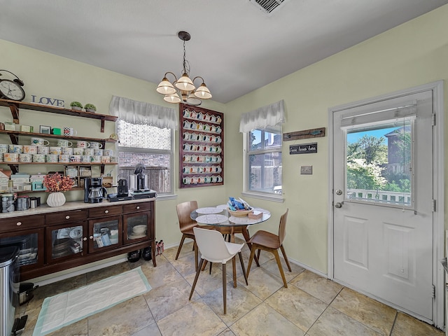 dining space with an inviting chandelier