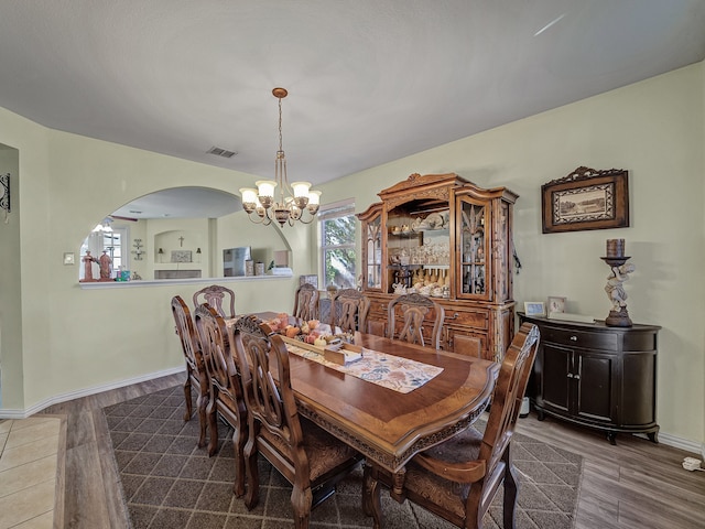 dining space featuring hardwood / wood-style flooring and a notable chandelier