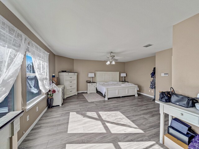 bedroom featuring light hardwood / wood-style floors and ceiling fan