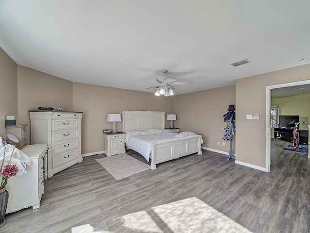 bedroom with ceiling fan and light hardwood / wood-style floors