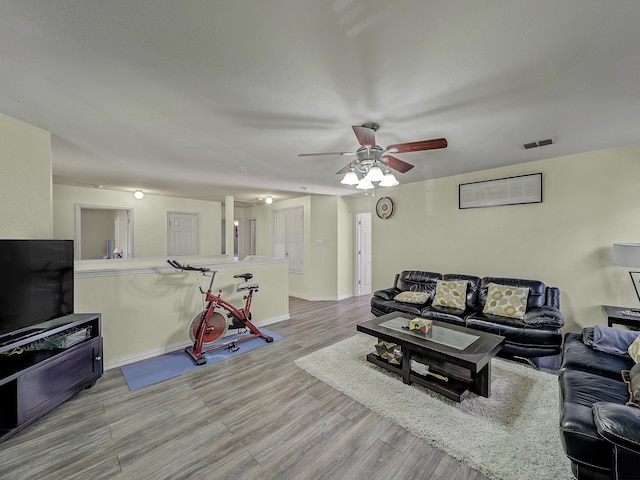 living room with ceiling fan and light wood-type flooring