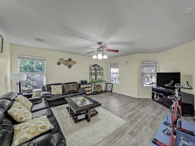 living room featuring hardwood / wood-style flooring, ceiling fan, and a wealth of natural light