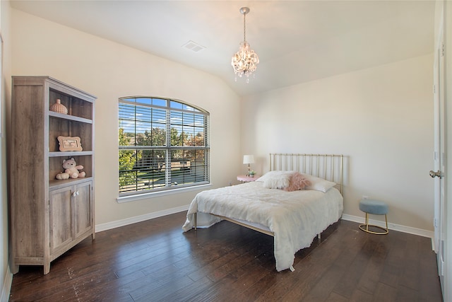 bedroom with dark hardwood / wood-style floors, lofted ceiling, and an inviting chandelier