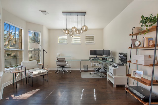 home office featuring dark wood-type flooring and a chandelier