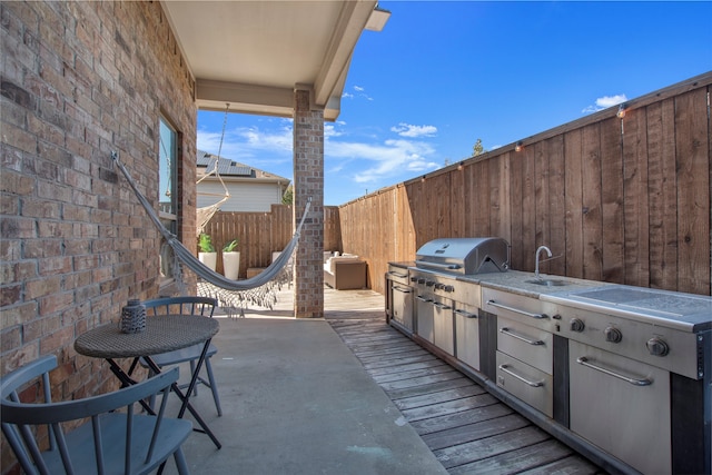 view of patio with area for grilling, grilling area, and sink