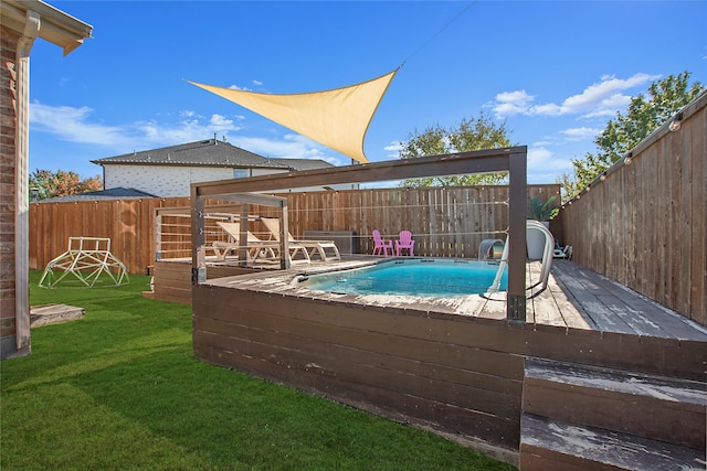 view of pool featuring a yard and a wooden deck