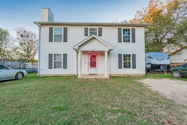 colonial-style house with a front lawn