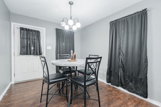 dining room with a chandelier and dark wood-type flooring