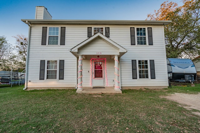 colonial inspired home with a front yard