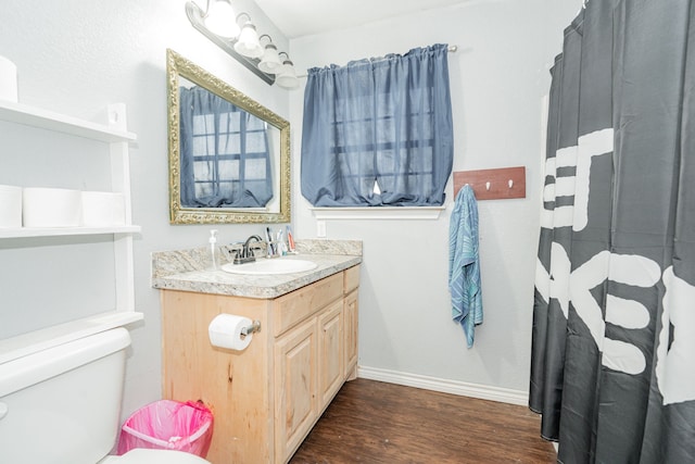 bathroom with hardwood / wood-style floors, vanity, and toilet