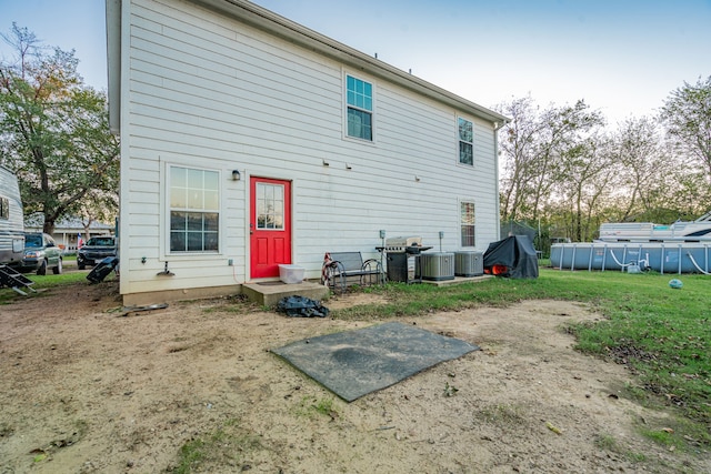 back of property featuring a swimming pool