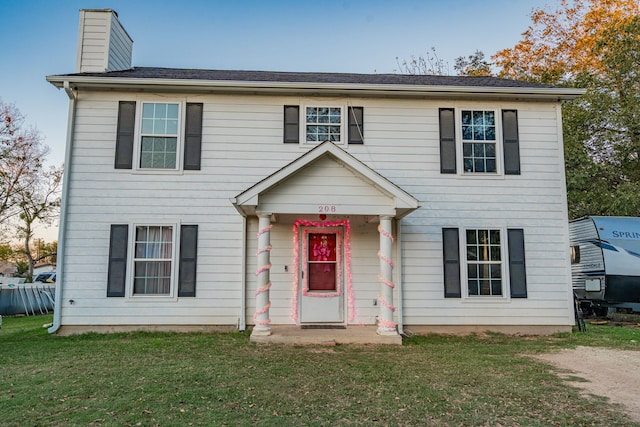 colonial home with a front yard