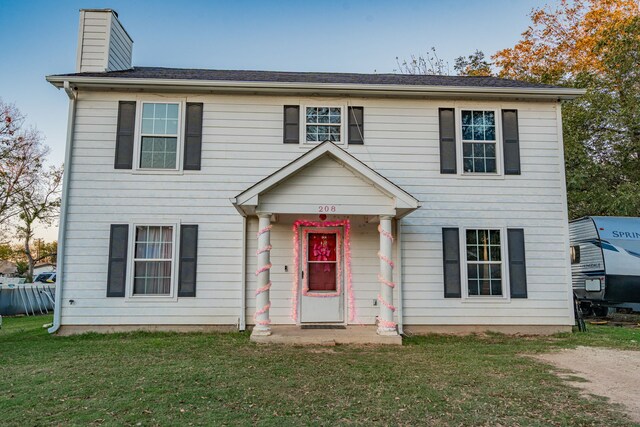 colonial home with a front yard