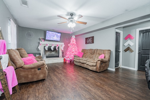 living room featuring ceiling fan and dark wood-type flooring