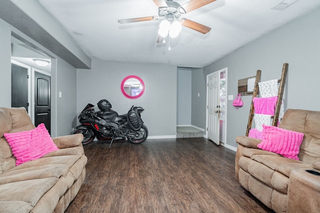 living room with ceiling fan and dark wood-type flooring