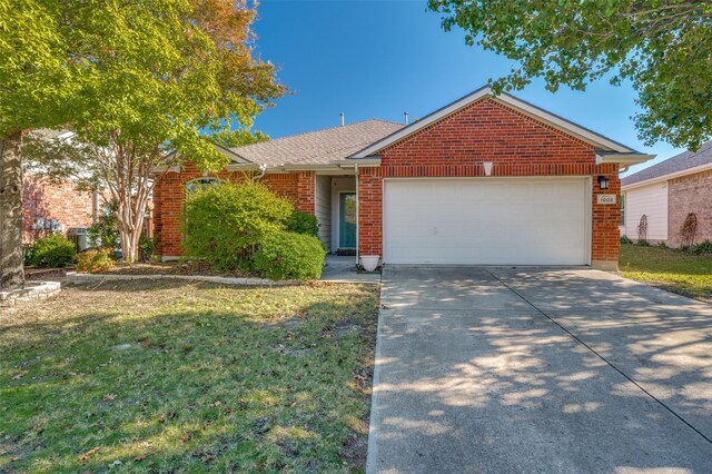 single story home featuring a front yard and a garage