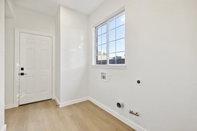 washroom featuring washer hookup, light hardwood / wood-style flooring, gas dryer hookup, and electric dryer hookup