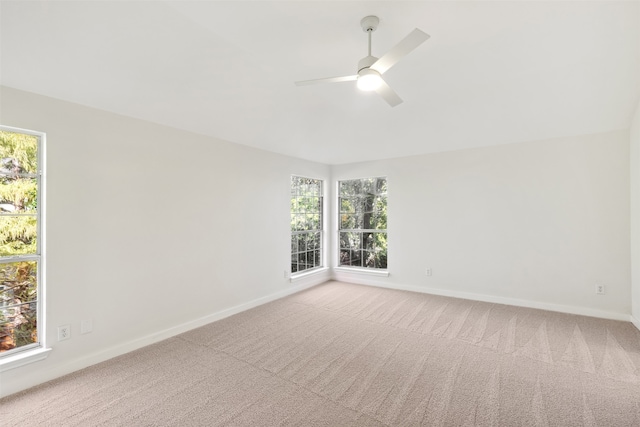 carpeted spare room featuring ceiling fan