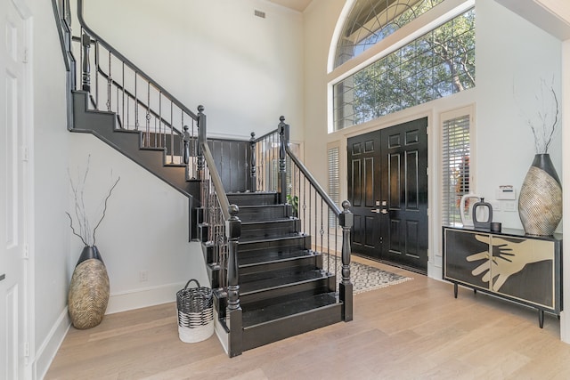 entryway with a high ceiling and hardwood / wood-style flooring