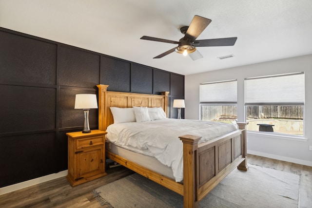 bedroom with ceiling fan and wood-type flooring