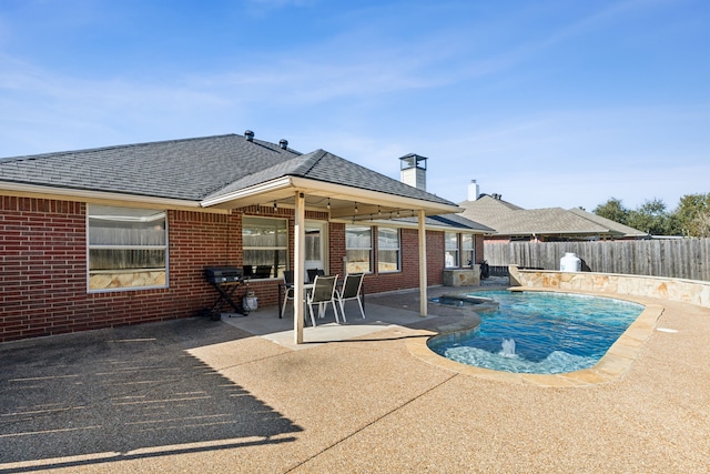 view of pool with pool water feature and a patio