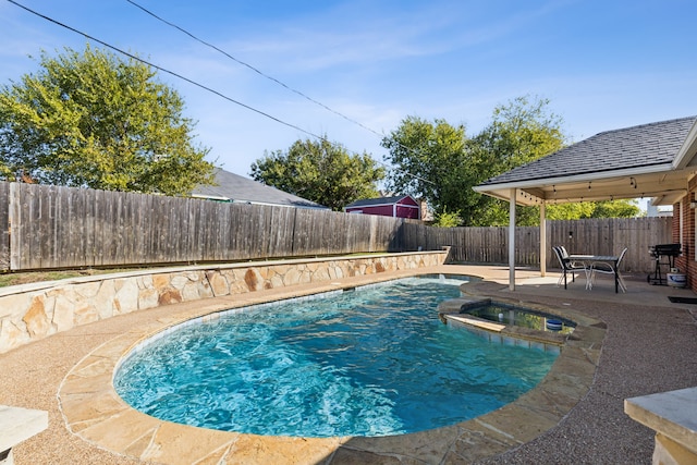 view of pool featuring a patio area and an in ground hot tub