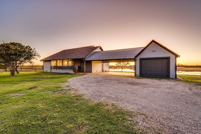 view of front of house with a carport and a lawn