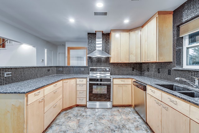 kitchen featuring wall chimney exhaust hood, light brown cabinets, sink, and stainless steel appliances