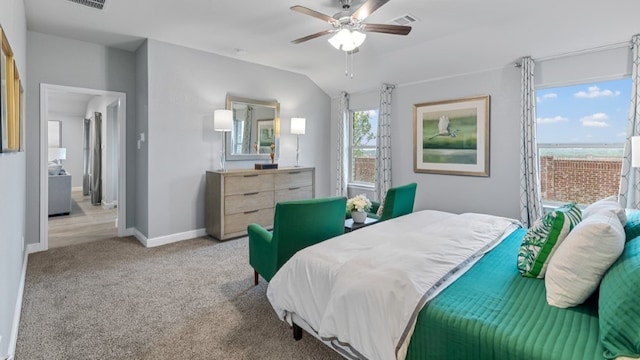 bedroom featuring ceiling fan, light colored carpet, and vaulted ceiling