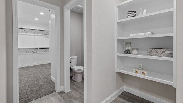 bathroom featuring hardwood / wood-style floors and toilet