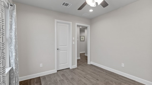 unfurnished bedroom with ceiling fan and light wood-type flooring