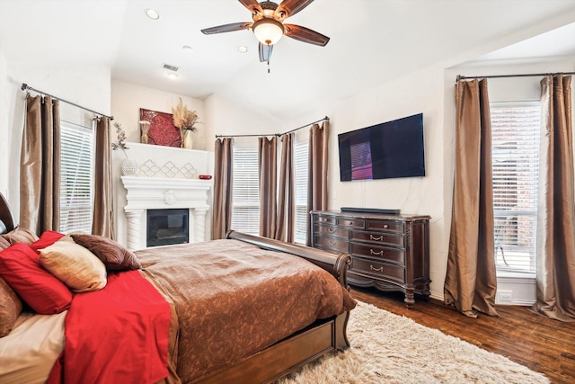 bedroom with dark hardwood / wood-style floors, ceiling fan, and lofted ceiling