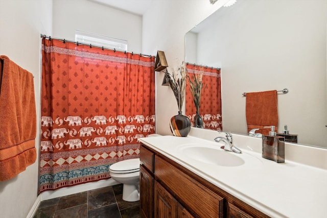 bathroom with vanity, curtained shower, and toilet