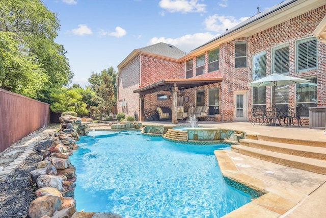 view of pool featuring pool water feature and a patio